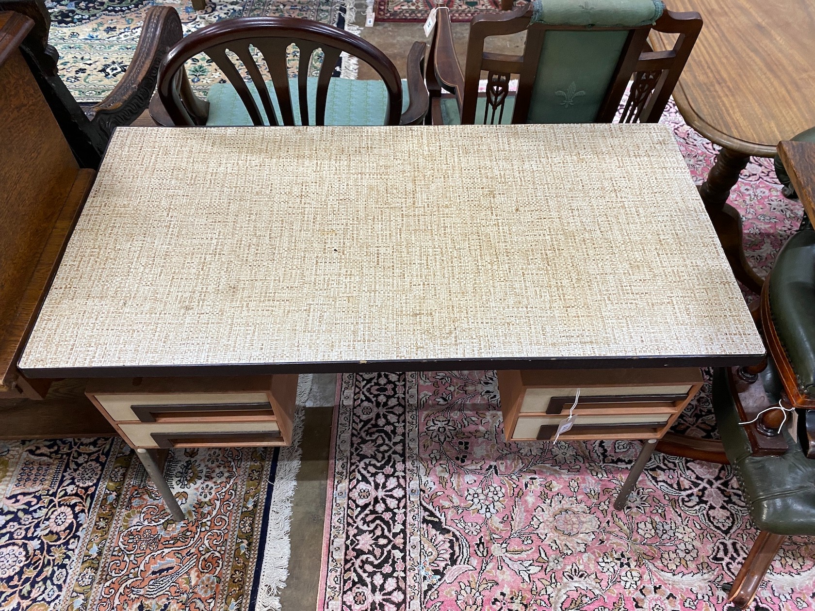 A 1970's kneehole desk with faux rattan top, length 109cm, depth 54cm, height 73cm